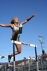 women jumping hurdle